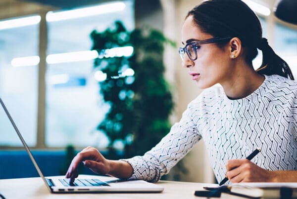 Resources - Business Woman Using a Computer to Get Insurance Resources