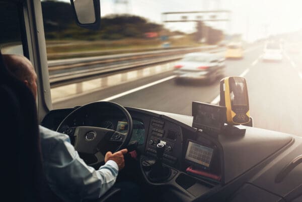 Business Auto Telematics Insurance - Interior of Cab of a Truck With Driver in Motion on a Highway