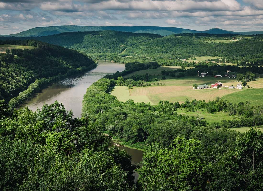 Danielsville, PA - Aerial View of a Rural Area in Danielsville Pennsylvania with a Farm Next to the River Surrounded by Mountains